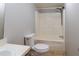Bathroom featuring a toilet and tub/shower combination at 13811 County Road 109D, Lady Lake, FL 32159