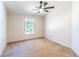 Bedroom featuring natural light, a ceiling fan, and neutral walls at 13811 County Road 109D, Lady Lake, FL 32159
