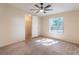 Bedroom with ceiling fan, natural light, and direct access to walk-in closet at 13811 County Road 109D, Lady Lake, FL 32159