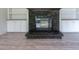 Close-up on living room fireplace featuring stone surround and built-in shelving at 13811 County Road 109D, Lady Lake, FL 32159