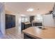 Bright kitchen featuring an island, stainless appliances, dark cabinets and adjacent dining area at 13811 County Road 109D, Lady Lake, FL 32159