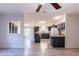 Open concept kitchen featuring dark cabinets, modern appliances, and an island with seating at 13811 County Road 109D, Lady Lake, FL 32159