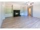 Open living room featuring a fireplace with built-in shelves and wood-look flooring at 13811 County Road 109D, Lady Lake, FL 32159