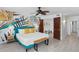 Main bedroom with king bed, tropical wall art, and ensuite access at 1420 N Atlantic Ave # 302, Daytona Beach, FL 32118