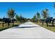 Long paved pathway with benches and trees at 14914 Harvest St, Orlando, FL 32824