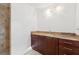 Bathroom vanity featuring stone countertop, dark cabinets and a decorative light fixture at 1504 E Robinson St, Orlando, FL 32801