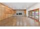 Large living area featuring a brick fireplace, wood paneling, and sliding glass doors to the outdoors at 1504 E Robinson St, Orlando, FL 32801