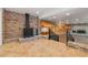 Spacious living area with brick accents, featuring a rustic wood stove and access to multiple entertainment zones at 1504 E Robinson St, Orlando, FL 32801