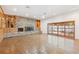 Expansive living room featuring a brick fireplace, built-in cabinets, and a wall of windows for natural light at 1504 E Robinson St, Orlando, FL 32801