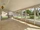 Enclosed sunroom with stone flooring, large windows, and a hanging porch swing at 236 N Ranger Blvd, Winter Park, FL 32792