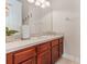 Clean bathroom with wood vanity and updated fixtures at 2555 Rose Spring Dr, Orlando, FL 32825