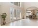 Bright and airy foyer with double doors and view to dining room at 2555 Rose Spring Dr, Orlando, FL 32825