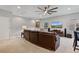 Upstairs living room showcasing a sectional sofa, TV, and natural light at 2977 Rapollo Ln, Apopka, FL 32712