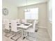Bright dining room with white table and chairs at 3151 Paradox Cir # 405, Kissimmee, FL 34746