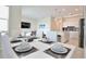 Modern dining area with white table and kitchen view at 3151 Paradox Cir # 405, Kissimmee, FL 34746
