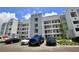 Apartment building exterior with parking and landscaping at 3151 Paradox Cir # 405, Kissimmee, FL 34746