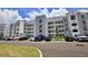 Apartment building exterior with parking and landscaping at 3151 Paradox Cir # 405, Kissimmee, FL 34746