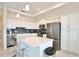 Modern kitchen with white cabinets, stainless steel appliances, and an island at 3151 Paradox Cir # 405, Kissimmee, FL 34746