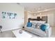 Bright and airy living room with a view into the kitchen area at 3151 Paradox Cir # 405, Kissimmee, FL 34746