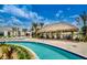 Tropical pool area with a tiki bar and lounge chairs at 3151 Paradox Cir # 405, Kissimmee, FL 34746