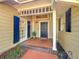 Welcoming entryway with brick flooring, blue shutters, and a charming door at 370 E Lake Sue Ave, Winter Park, FL 32789