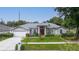 Single-story home with gray siding, red door, and attached garage at 4265 Conway Place Cir, Orlando, FL 32812