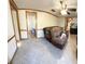 Spacious living room with a large couch and tile flooring at 475 80 Foot Rd, Bartow, FL 33830