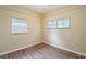 Well-lit bedroom with wood-look floors and dual windows at 5219 Montague Pl, Orlando, FL 32808
