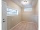 Small laundry room with tile flooring and window at 5219 Montague Pl, Orlando, FL 32808