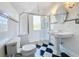 Elegant bathroom with pedestal sink and checkerboard floors at 527 Broadway Ave, Orlando, FL 32803