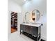 Double vanity bathroom with walk-in closet access at 527 Broadway Ave, Orlando, FL 32803