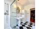 Stylish bathroom with a walk-in shower and checkerboard floor at 527 Broadway Ave, Orlando, FL 32803