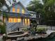 Back exterior view of home with lit windows and pool at 527 Broadway Ave, Orlando, FL 32803