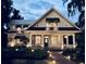 Inviting traditional home with a large front porch, manicured landscaping, and exterior lighting at 527 Broadway Ave, Orlando, FL 32803