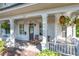Spacious front porch with rocking chairs and hanging planters at 527 Broadway Ave, Orlando, FL 32803