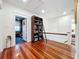 Upper hallway with hardwood floors and built-in shelves at 527 Broadway Ave, Orlando, FL 32803