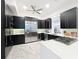 Modern kitchen with stainless steel appliances and dark cabinetry at 527 Broadway Ave, Orlando, FL 32803