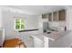 Modern galley kitchen with white cabinets and quartz countertops at 527 Broadway Ave, Orlando, FL 32803