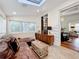 Sunlit living room featuring a leather sectional sofa and a mid-century modern cabinet at 527 Broadway Ave, Orlando, FL 32803