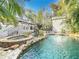 Stunning pool with a mermaid statue, waterfall, and spacious deck at 527 Broadway Ave, Orlando, FL 32803