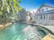 Luxury pool and spa with a waterfall and beautiful landscaping at 527 Broadway Ave, Orlando, FL 32803