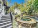 Inviting pool area with a spa, waterfall feature, and mermaid statue at 527 Broadway Ave, Orlando, FL 32803