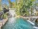 Resort-style pool with a waterfall, spa, and lush landscaping at 527 Broadway Ave, Orlando, FL 32803