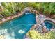 Inviting pool with dolphin fountain and spa; lush landscaping at 527 Broadway Ave, Orlando, FL 32803