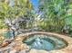 Relaxing stone spa with a mermaid fountain and tropical landscaping at 527 Broadway Ave, Orlando, FL 32803