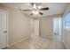 Bedroom with tile flooring, ceiling fan and access to a bathroom at 5511 Indian Hill Rd, Orlando, FL 32808