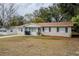 Tan house with brown roof, driveway, and small front yard at 5511 Indian Hill Rd, Orlando, FL 32808