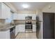 Updated kitchen features granite countertops and stainless steel appliances at 5511 Indian Hill Rd, Orlando, FL 32808