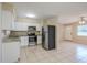 Kitchen with white cabinets, granite counters, and stainless steel appliances at 5511 Indian Hill Rd, Orlando, FL 32808