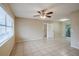 Living room with tile floors and access to kitchen and patio at 5511 Indian Hill Rd, Orlando, FL 32808